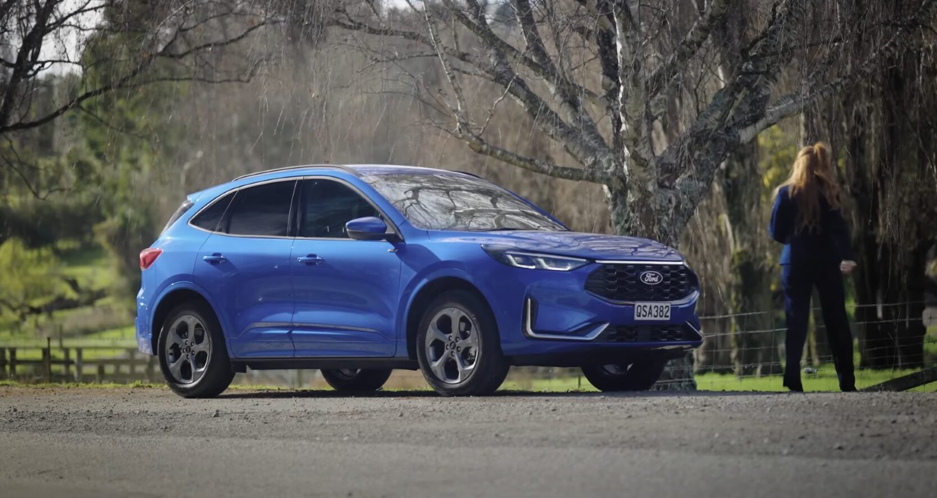 Professional flatbed towing of blue SUV outdoors near Hollister, CA